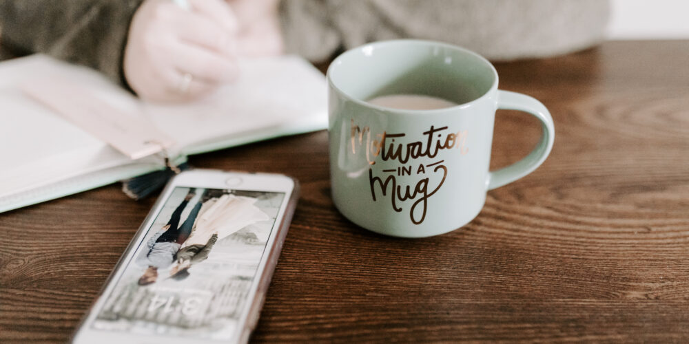 Phone on table with coffee mug for how to be smart about kids' tech use.