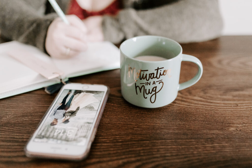 Phone on table with coffee mug for how to be smart about kids' tech use.