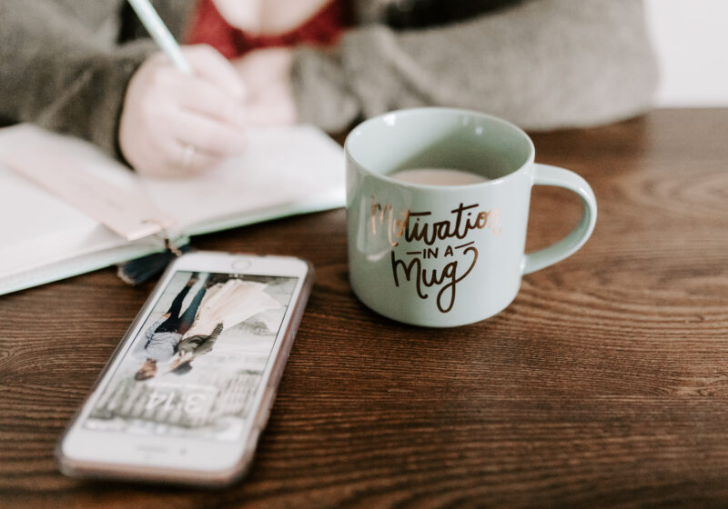 Phone on table with coffee mug for how to be smart about kids' tech use.