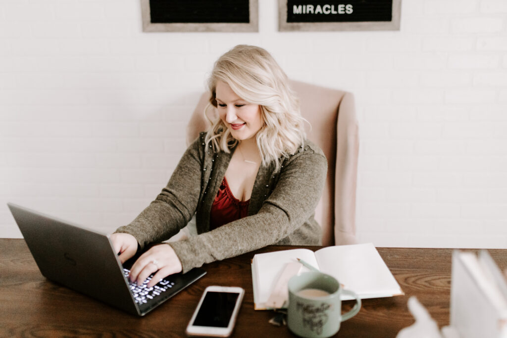 Woman working on computer determining what type of business to start.