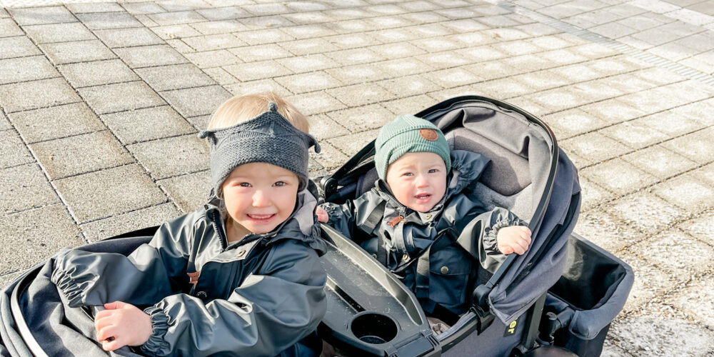 Two kids in veer stroller.