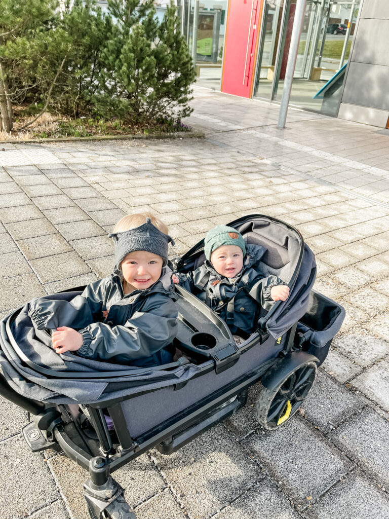 Two kids in veer stroller.