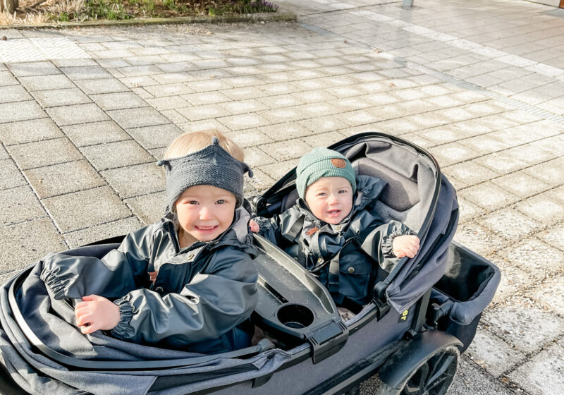 Two kids in veer stroller.