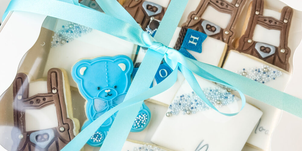 Baby shower cookies in box with bow.
