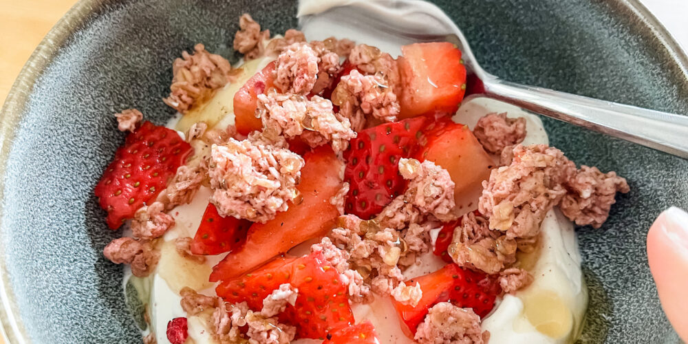 Yogurt parfait in bowl with spoon for cooking at home.