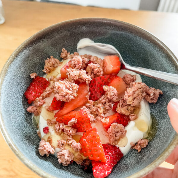 Yogurt parfait in bowl with spoon for cooking at home.