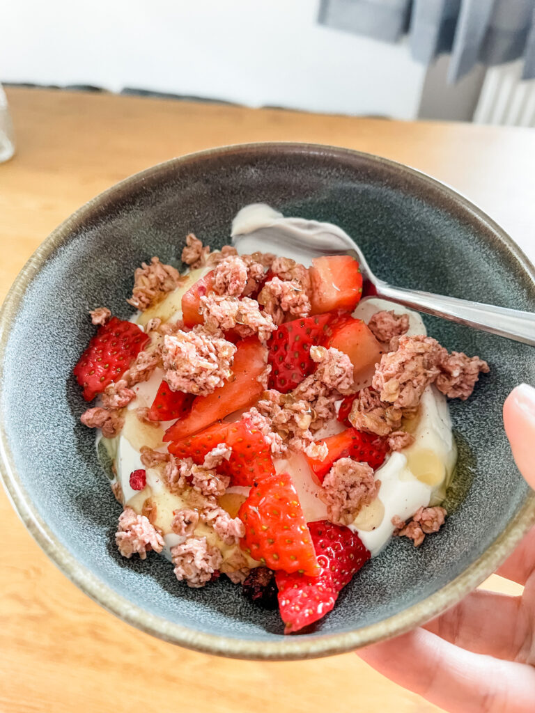 Yogurt parfait in bowl with spoon for cooking at home.