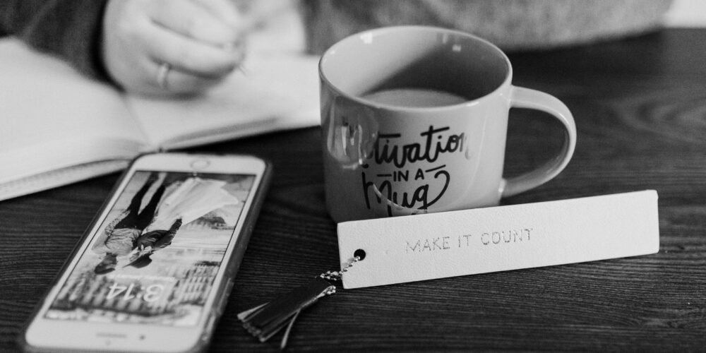 Phone and coffee mug on desk.