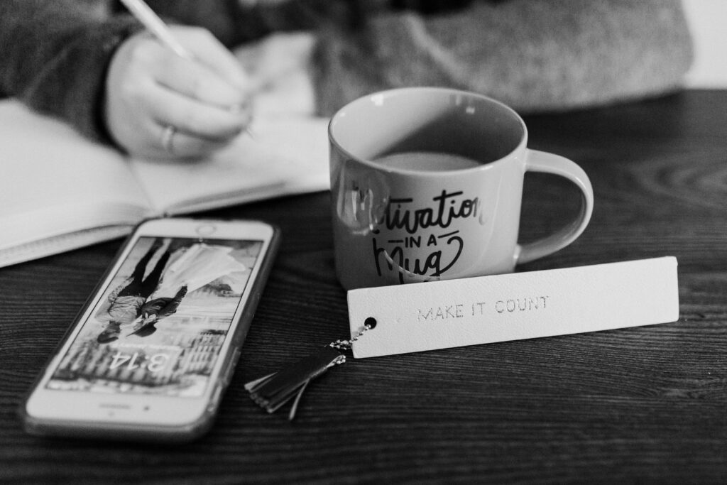 Phone and coffee mug on desk. 